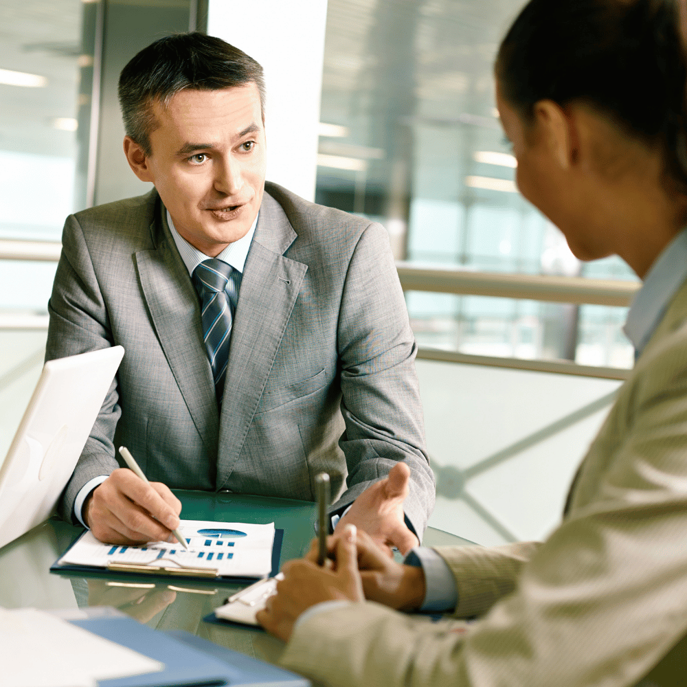 Consultant and client in Greater Noida office reviewing financial charts and data during a professional consulting session